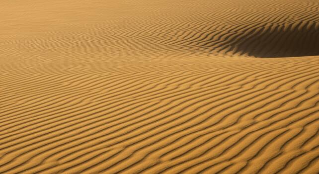 A mesmerizing view of endless sand dunes with beautiful wave patterns created by the desert wind in the vast expanse of arid landscape. photo