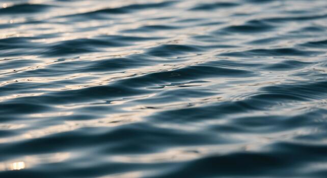 Gentle ripples create a mesmerizing pattern across the water's surface, reflecting sunlight in a serene and calming oceanic vista. photo