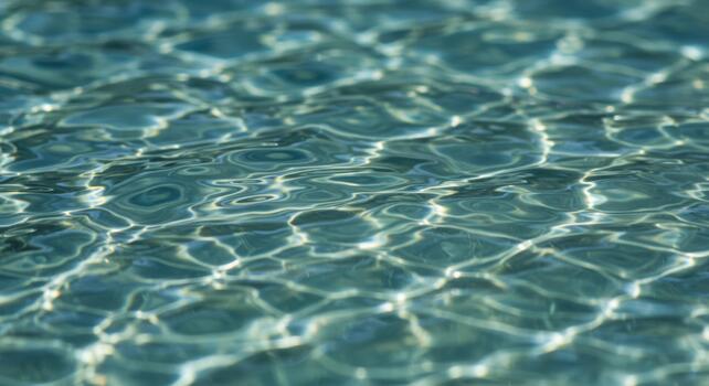 espumoso turquesa agua superficie refleja luz de sol creando resumen patrones ese imitar delicado las venas en esta hermosa verano escenario. foto