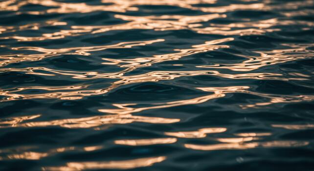 Sunlight reflects warmly on a dark blue ocean with gentle waves creating a beautiful and calming natural scene on the water surface. photo