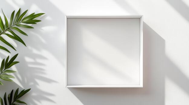 A white square frame on a wall next to a palm tree photo