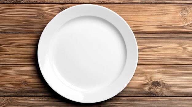 Empty white plate on wooden table top view photo