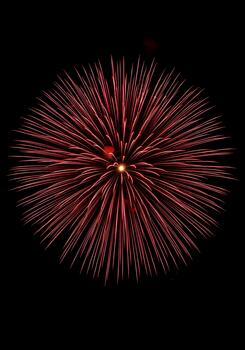 Burst of Red Fireworks Exploding in the Night Sky a Celebration of Light and Color Capturing the Magic of a Festive Event photo