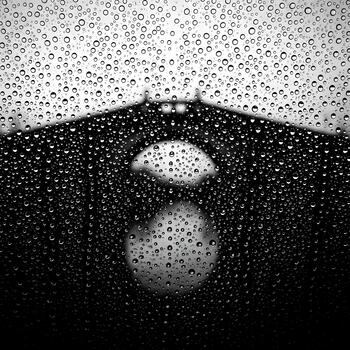 Abstract Monochrome of Raindrops on Glass with Blurred Building Reflection a Study in Texture and Light Creating a Dreamy Atmospheric Scene photo