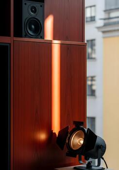 Studio Lighting Setup with Bookshelf Speaker and Natural Light Beam Creating a Dramatic Visual Composition for Interior Design and Sound Engineering Concepts photo