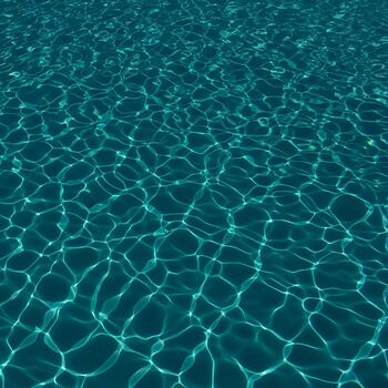 Mesmerizing turquoise water surface shimmering with sunlight creating abstract patterns ideal for backgrounds and creative projects showcasing the beauty and serenity of aquatic environments photo