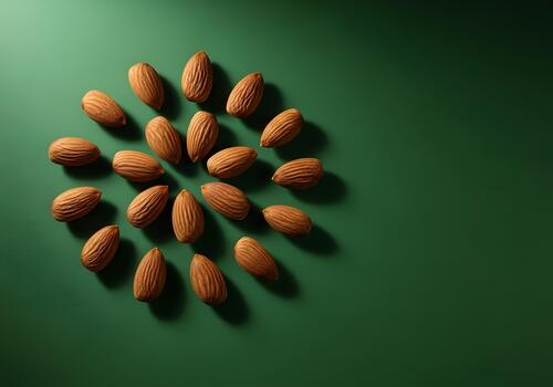 Overhead View of Almonds Arranged in a Circular Pattern on a Dark Green Background with Ample Copy Space for Health and Wellness Messages photo