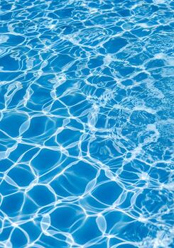 Sunlight Dancing on the Blue Water Surface of a Swimming Pool Creating Abstract Patterns and Reflections on a Summer Day Perfect for Backgrounds and Textures photo