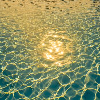 Sunlight Dancing on Pool Water Surface Creating Abstract Patterns and Reflecting Summer Warmth Creating a Relaxing and Serene Ambience Perfect for Summer Relaxation photo