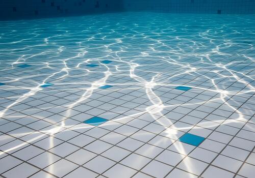 Tranquil underwater view of a swimming pool floor reflecting sunlight creating mesmerizing patterns perfect for summer concepts and relaxation imagery evoking a sense of calm and peace photo