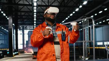 African american worker uses VR headset during technology training session on the factory floor, showing labor strength for industrial development. Improving heavy production practices. Camera B. video