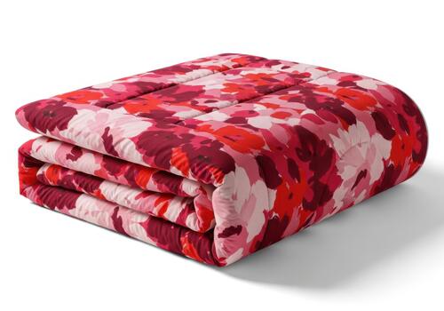 Folded floral patterned blanket isolated on white background photo
