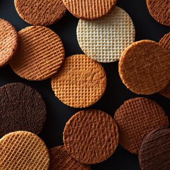 Overhead Shot of Assorted Stroopwafels on Dark Surface photo