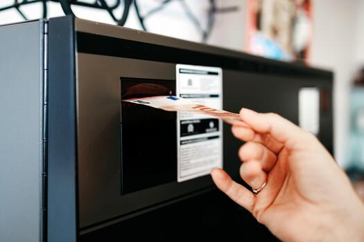 Hand inserting a credit card into a payment terminal, showcasing modern technology and convenience in a retail environment with clear branding and user interaction photo