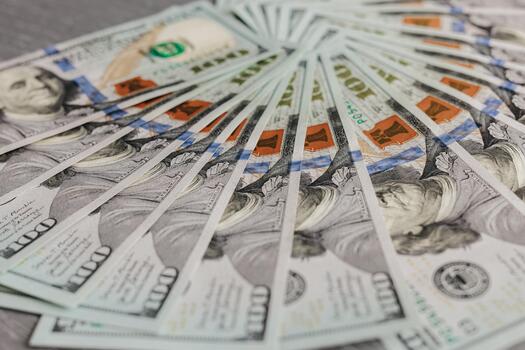 Stacks of hundred-dollar bills arranged in a circular pattern on a textured surface, showcasing the intricate details of currency and the concept of wealth and finance photo