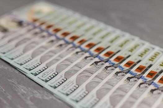 Stacks of colorful banknotes arranged neatly on a textured surface, showcasing intricate designs and security features, representing currency and financial transactions photo