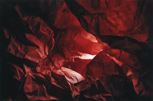 Textured red paper creates a dynamic abstract landscape photo