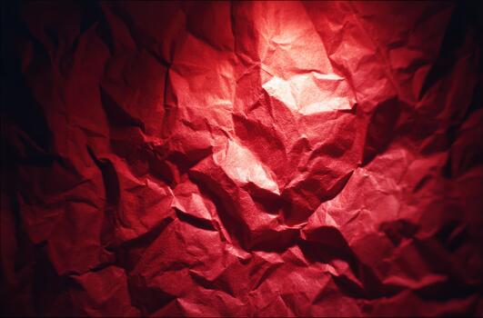 Textured red paper with dramatic lighting in the background photo