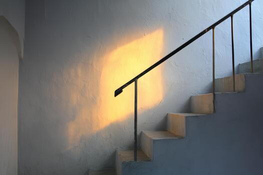 Light casts warm glow on stairwell in quiet setting photo