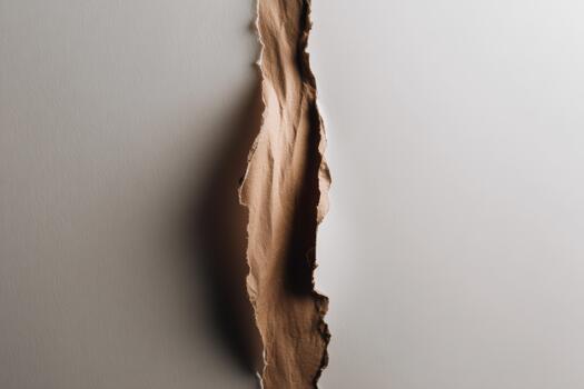 Torn paper reveals a contrasting surface behind photo