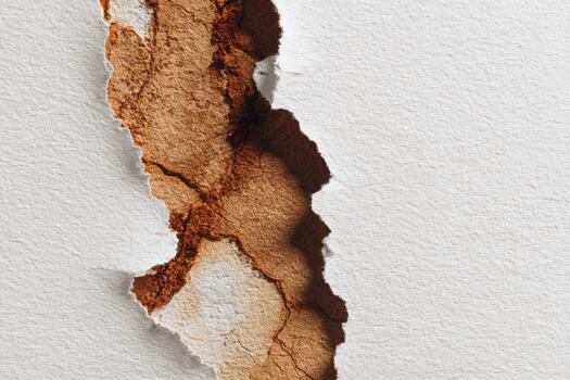 View of torn paper revealing brown texture photo