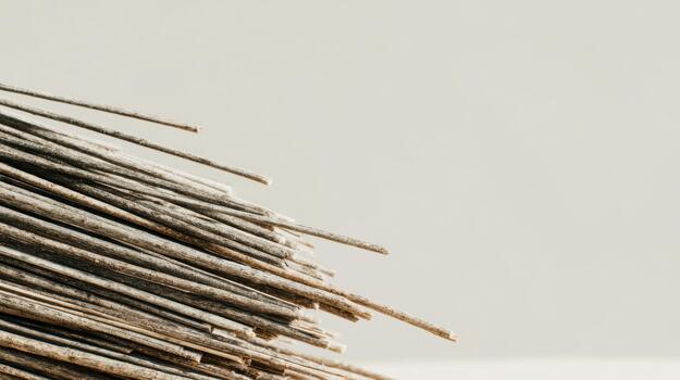 Stacked wooden sticks on a light background photo