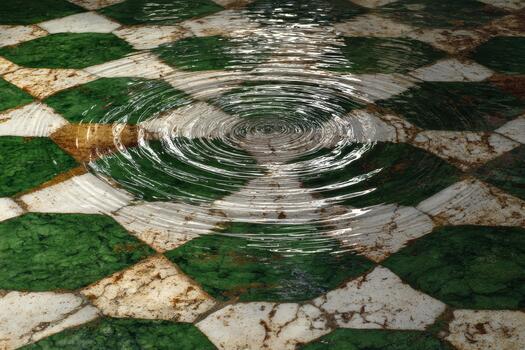 Ripples on a green and white tiled surface photo