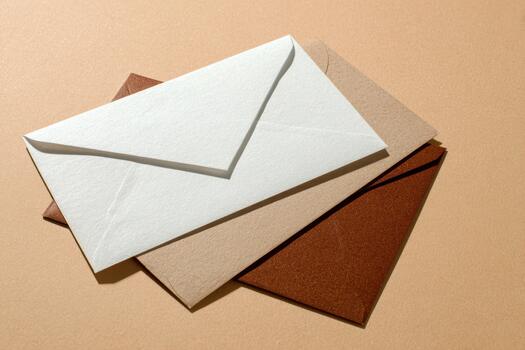 Colorful envelopes stacked on a plain background photo