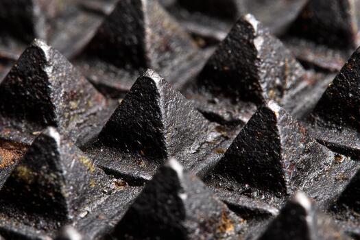 Close-up view of a textured metal surface with peaks photo