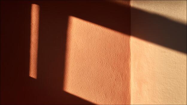 Shadows play on warm colored walls in softly lit room photo