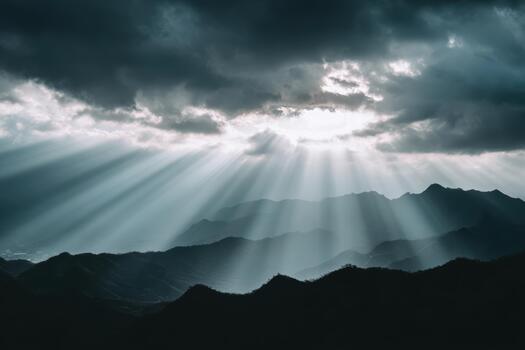 Rays of sunlight breaking through dark clouds over mountains photo