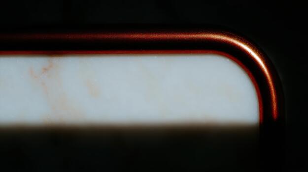 Close-up of a metallic edge on a marble surface photo