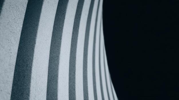 Curved concrete wall with dramatic shadows and light photo