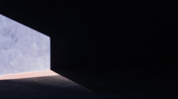 Light casts shadow in empty room at noon time photo