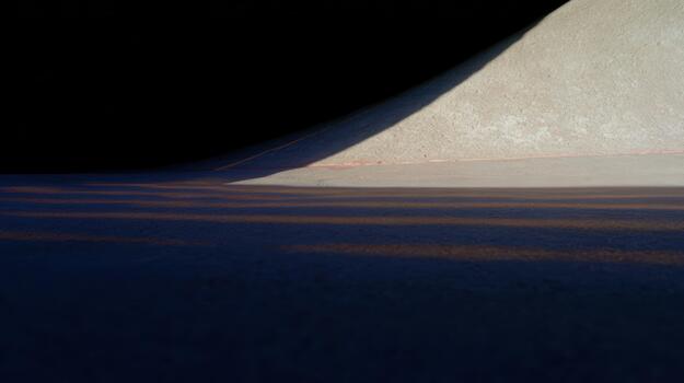 Shadows and curves on a sunny surface at dusk photo