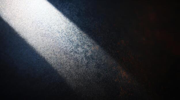Light beams create a dramatic effect on a textured surface photo