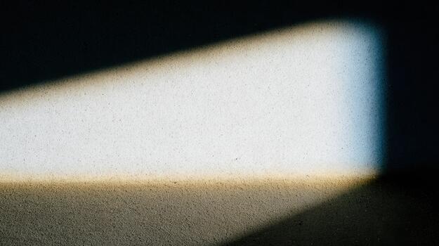 Light patterns create unique shapes on a textured surface photo