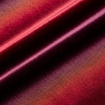 Abstract close up of rich red fabric with subtle iridescent shimmer and deep shadows creating a luxurious texture photo