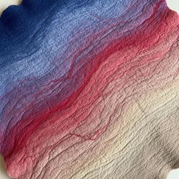 Vibrant gradient of blues purples reds and yellows flows across a textured fabric surface creating a beautiful abstract pattern photo