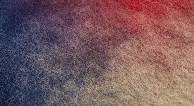 Abstract textured background with a gradient of deep blues transitioning to warm reds and earthy tones photo