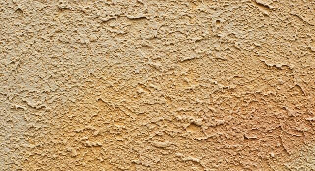 Close up textured abstract background of rough stucco with warm earthy tones and subtle color variations photo