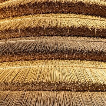 Close up view of stacked dried straw or hay bales creating a textured background with warm earthy tones and natural patterns photo