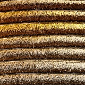 Close up abstract view of stacked dried straw or hay bales creating a textured horizontal pattern photo