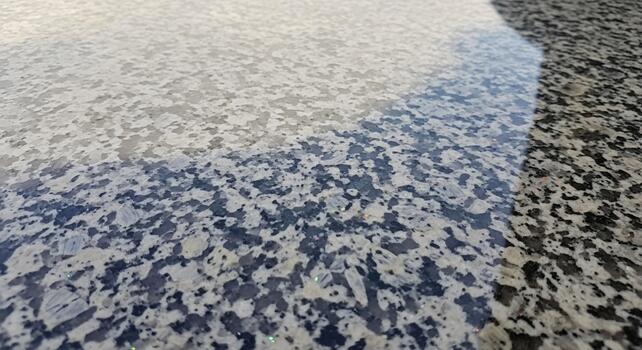 Abstract close up of textured surface with subtle color gradients and speckled patterns photo