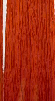 Vibrant abstract texture of vertical orange threads with subtle variations in shade and light photo