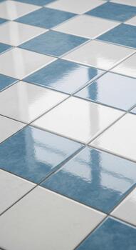 Geometric pattern of reflective blue and white square tiles creating a clean and modern floor surface with subtle light reflections photo