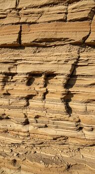 Close up view of weathered wooden planks with deep grain patterns and shadows creating abstract shapes photo
