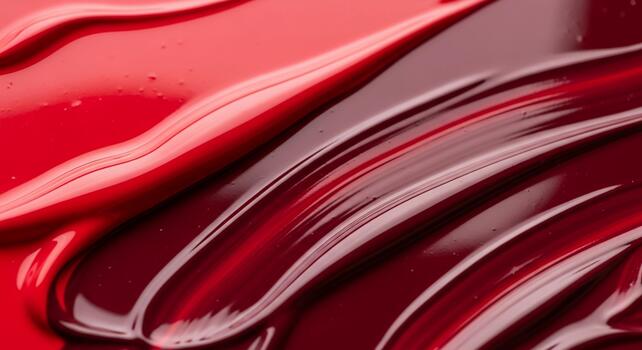 Close up abstract texture of swirling glossy red and deep crimson paint strokes creating a luxurious and vibrant visual photo