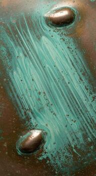 Close up of weathered copper surface with verdigris patina and visible brush strokes creating abstract texture photo