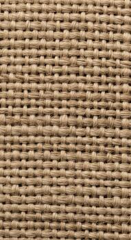 Close up view of a textured woven natural fiber fabric with a repeating pattern of interlaced threads photo